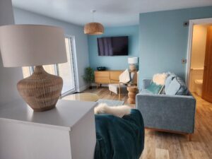 Hot tub residence living area with bifold doors looking out to the sea.